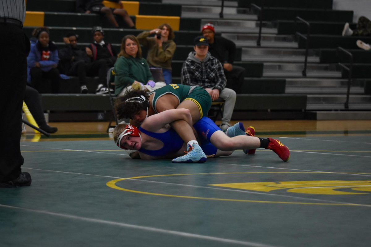 In a final pin attempt, a Kennedy wrestler holds his opponent to the ground.