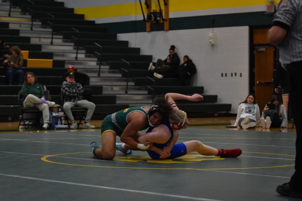 After a throw to the ground, a Kennedy wrestler begins to throw his opponent around.