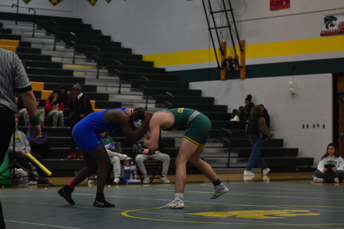 Tusseling at the shoulders, a Kennedy wrestler looks for an opening.