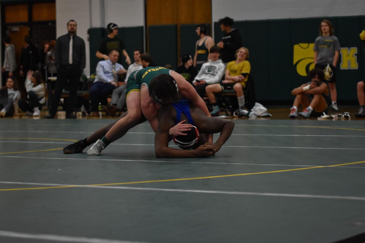 Gaining the advantage, a Kennedy Wrestler jumps on top of his opponent.