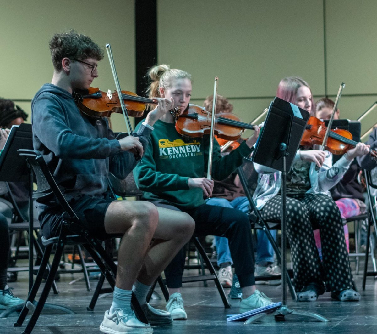 Violin members of the Kennedy Symphony Orchestra lead as an example for the Harding violins.