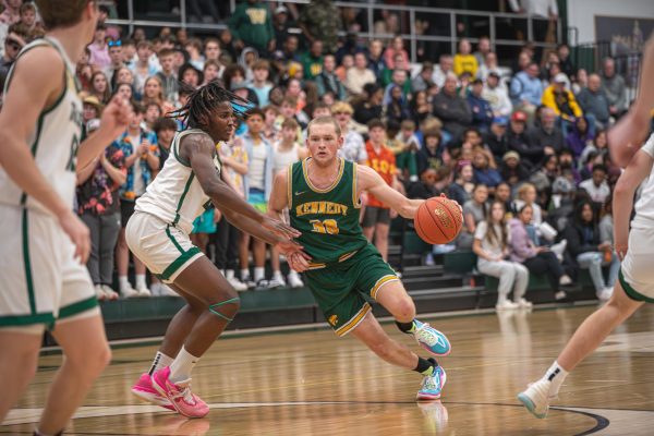 Bean drives to the hoop through Iowa City West defenders.