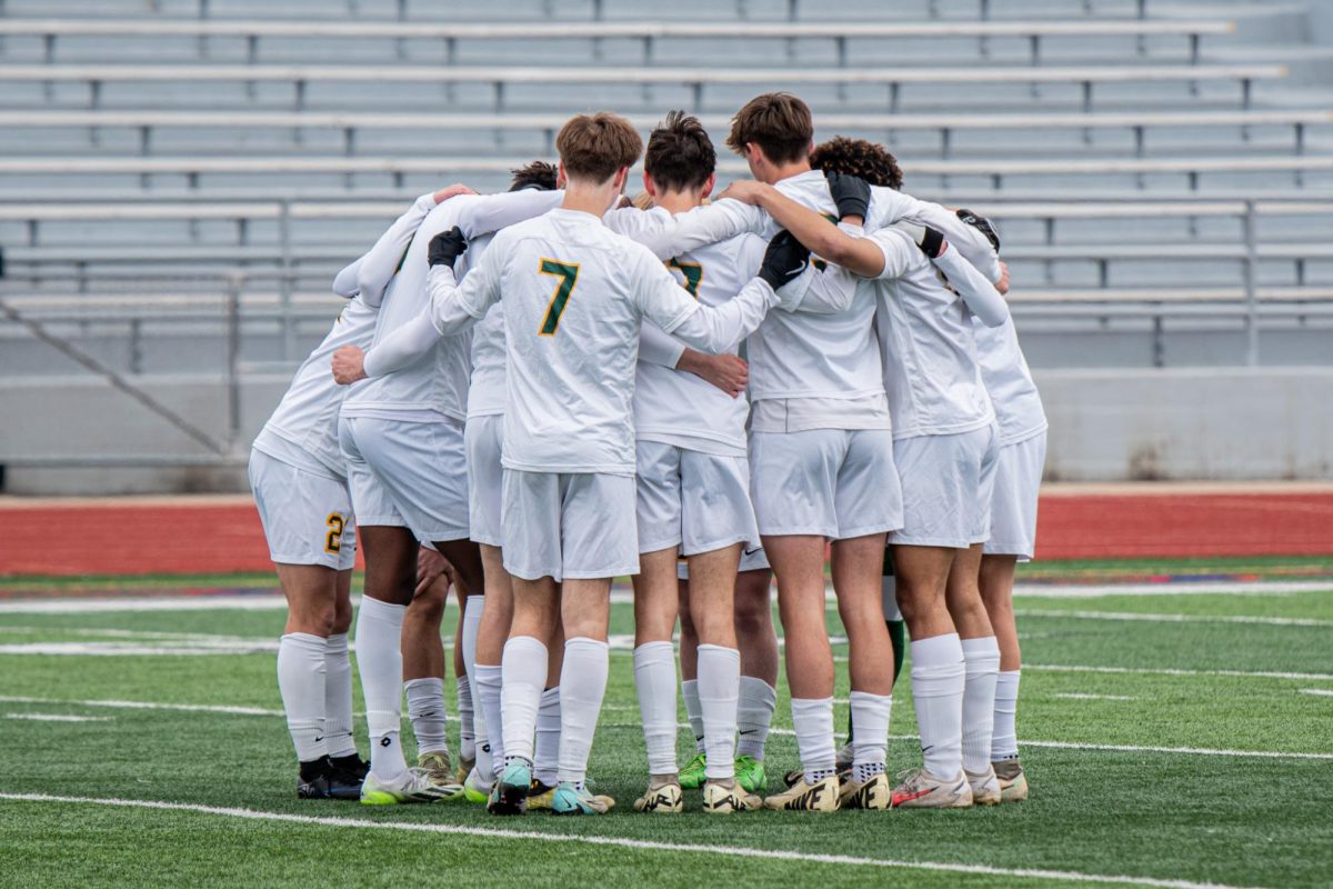 The Kennedy Boys Varsity Soccer Team comes together after the first half of the game. 
