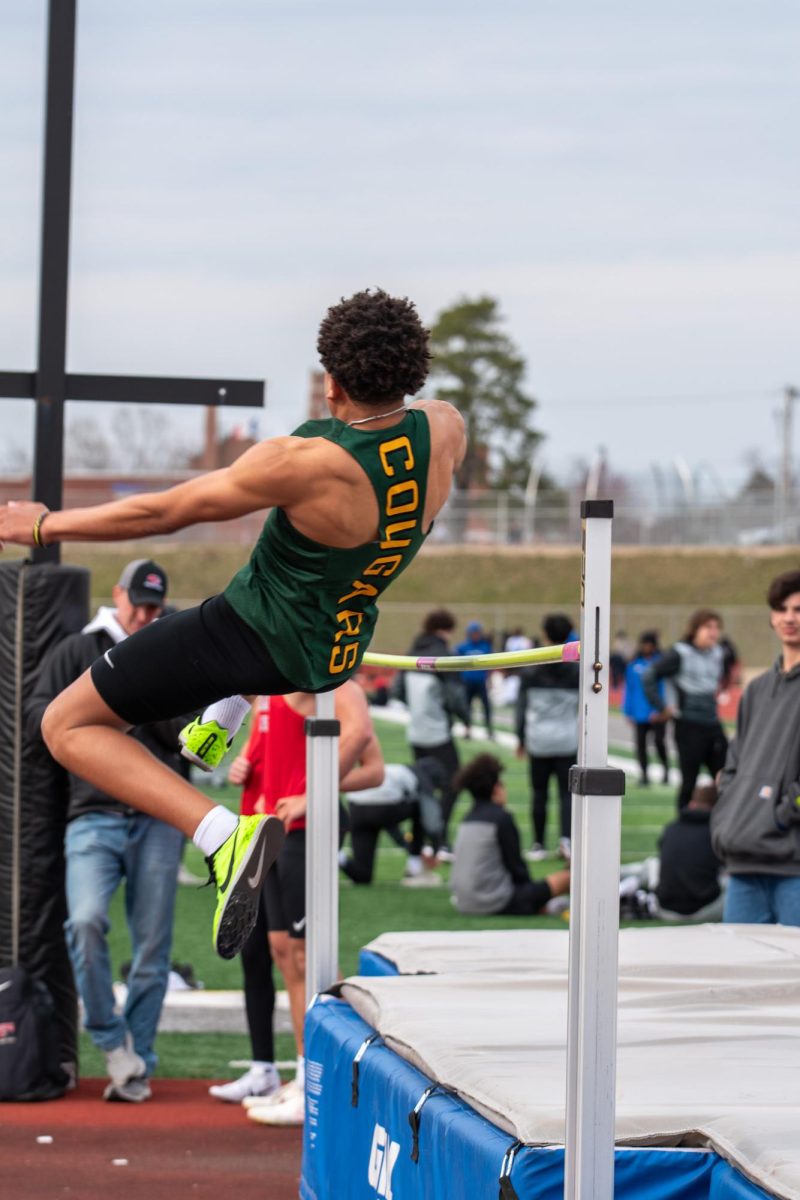 Freshman Isaiah Snead Jr. jumping over the pole/
