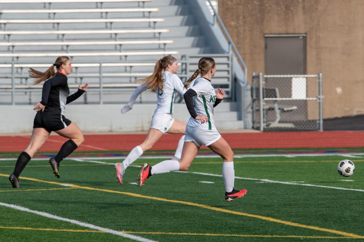 Kennedy Soccer players run to get the ball. 