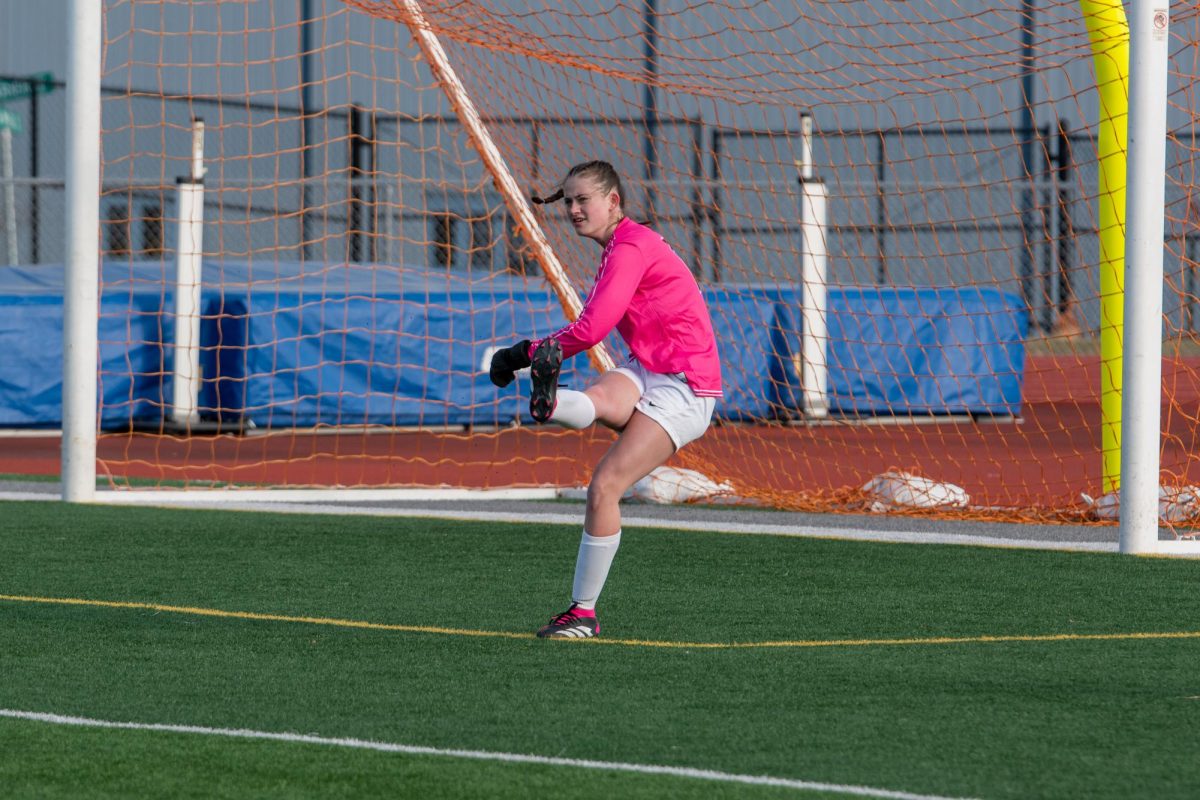 Senior Grace Hallam kicks the ball away from the goal. 