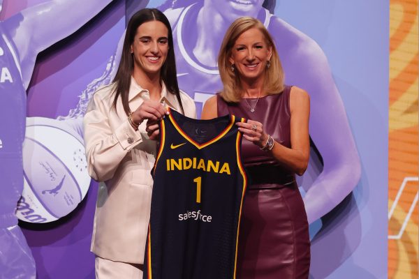 Caitlin Clark posing for a picture with WNBA Commissioner Cathy Engelbert after being chosen first overall to the Indiana Fever.