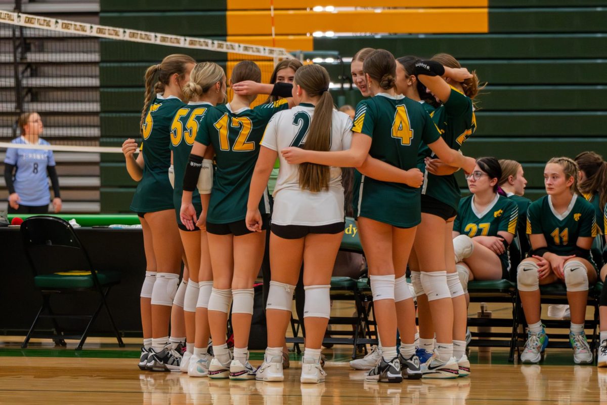 The Kennedy Freshman Volleyball Team huddles and plans for their first set.