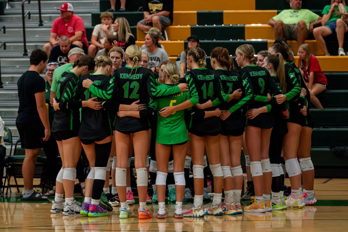 Kennedy's Varsity Volleyball Team huddles together during a timeout.