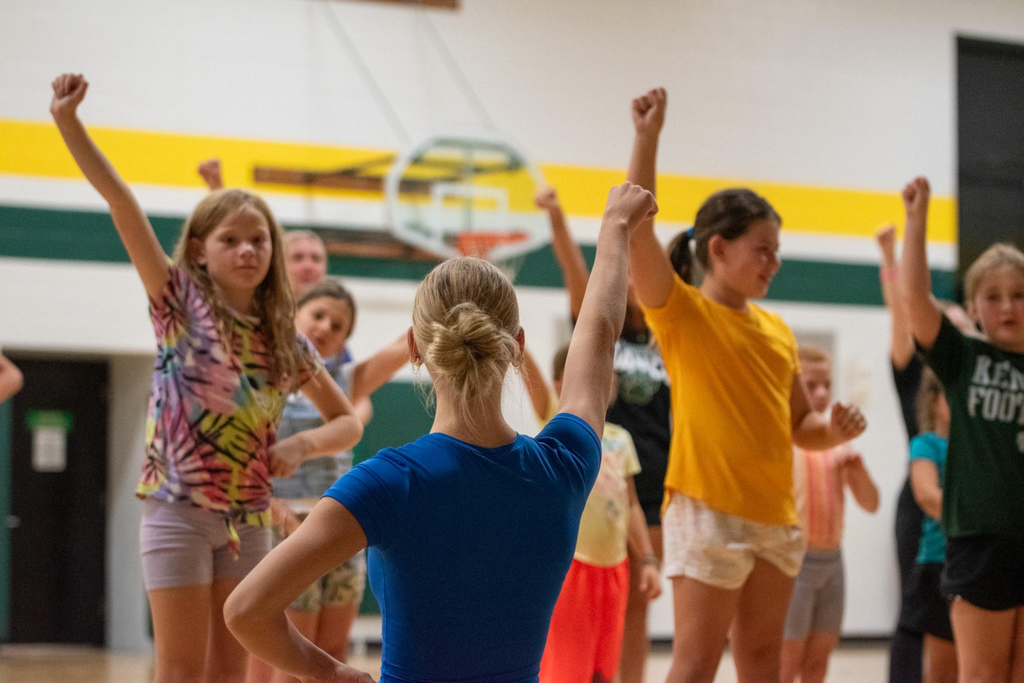 Senior Willa Bowman joins second and third graders in a cheer.