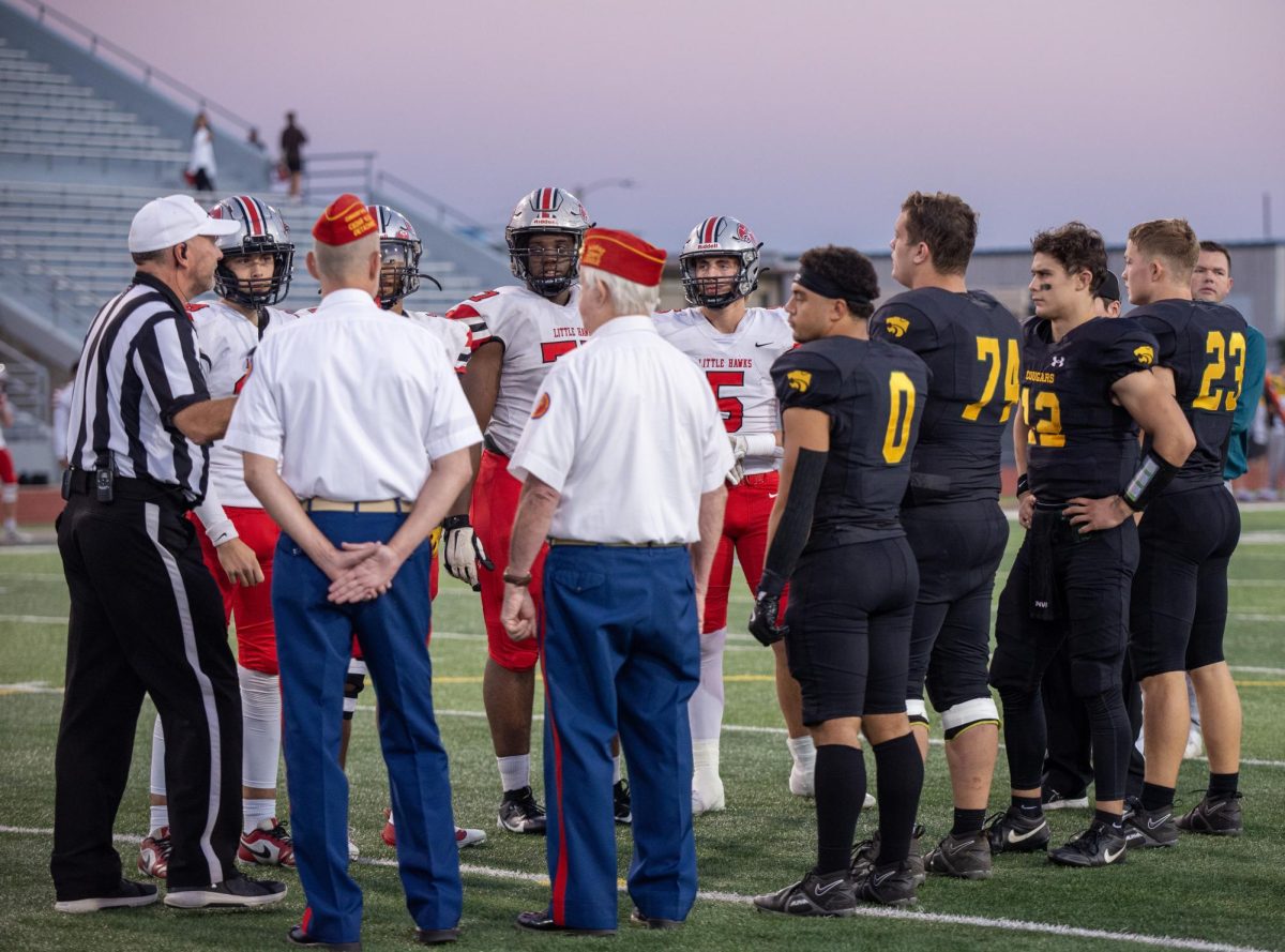 Team captains line up for the coin toss.