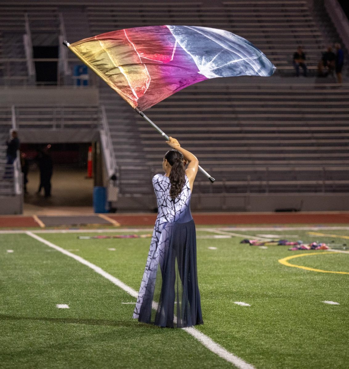 Kennedy's color guard accompanies the marching band's show "Shattered" with technicolor flags.