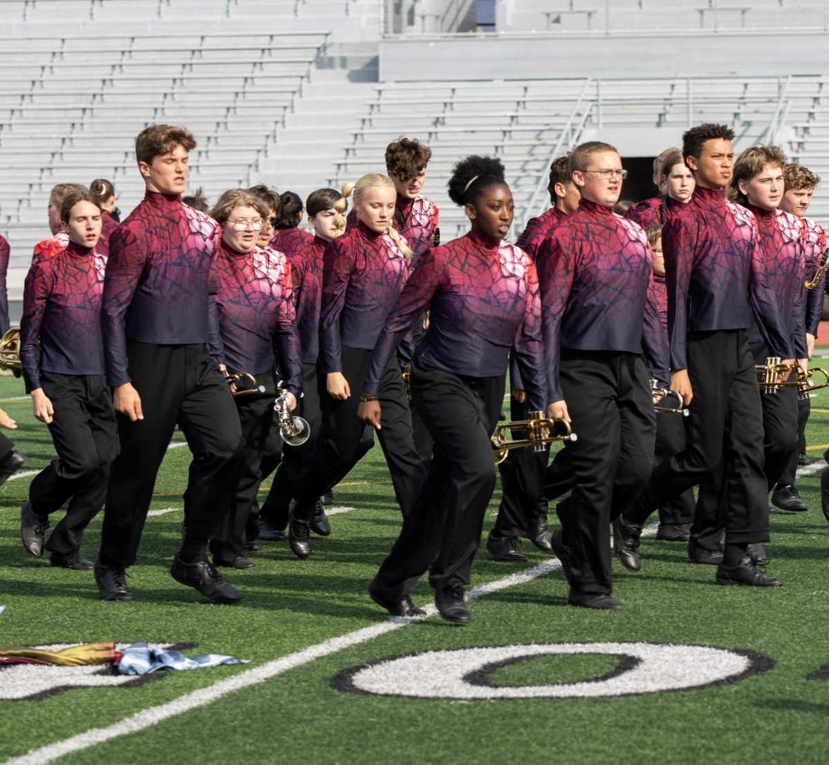 Band students walk onto the field.