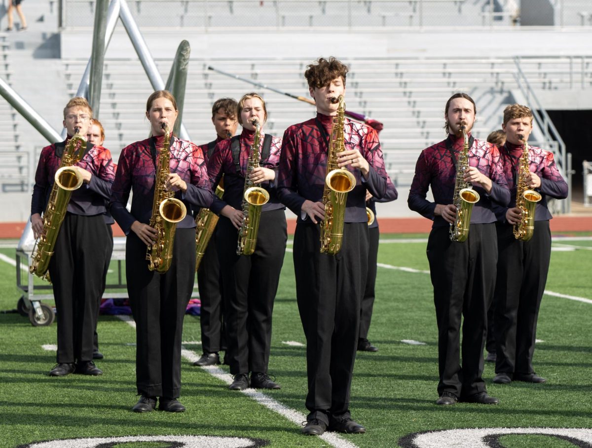 Saxophone players stand in a group.