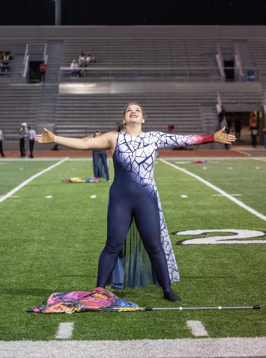 Color guard's show comes to a close with a big finish as senior Ellie Wray concludes her solo.