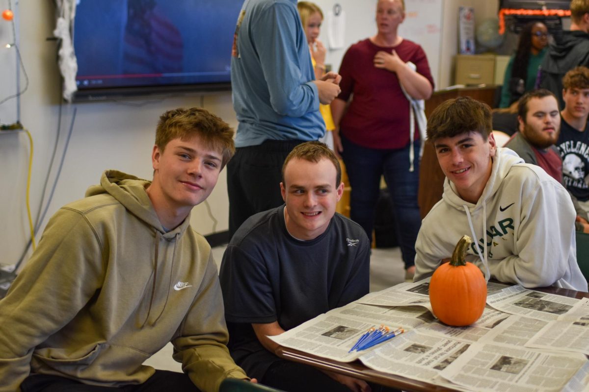 Sophomores Callum Fortune and Sam Myers assists John Bednar.