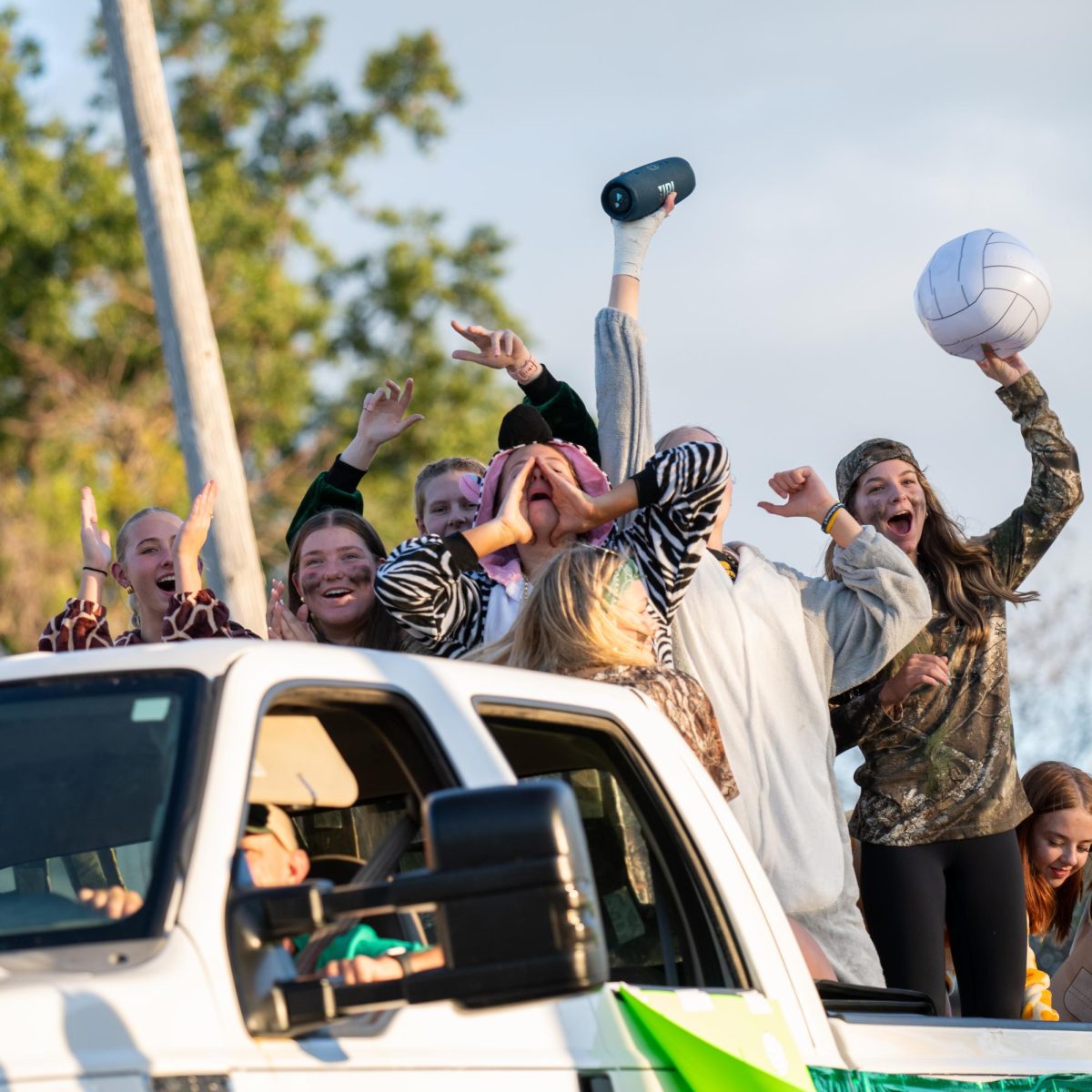 Welcoming Kennedy fans to the jungle, varsity volleyball cheers in the parade.