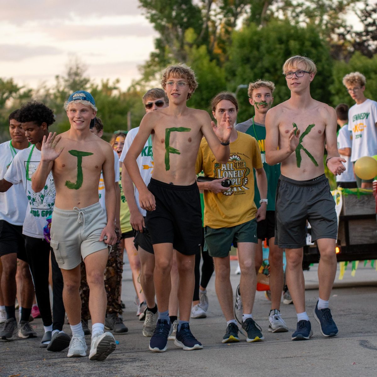 Juniors Nathaniel Goff and Lincoln McMahan and sophomore Neil Cogdill March for the cross country float.