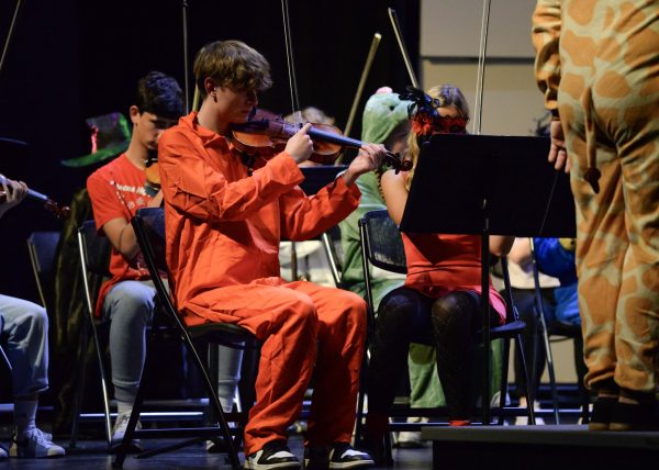 Senior Cade Beck plays his violin, focusing on his music. 