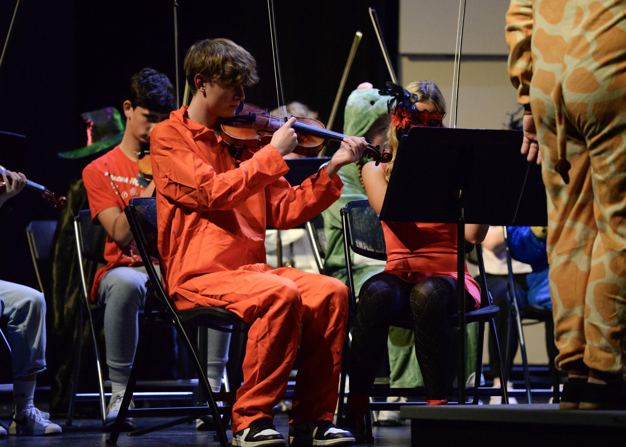 Senior Cade Beck plays his violin, focusing on his music. 