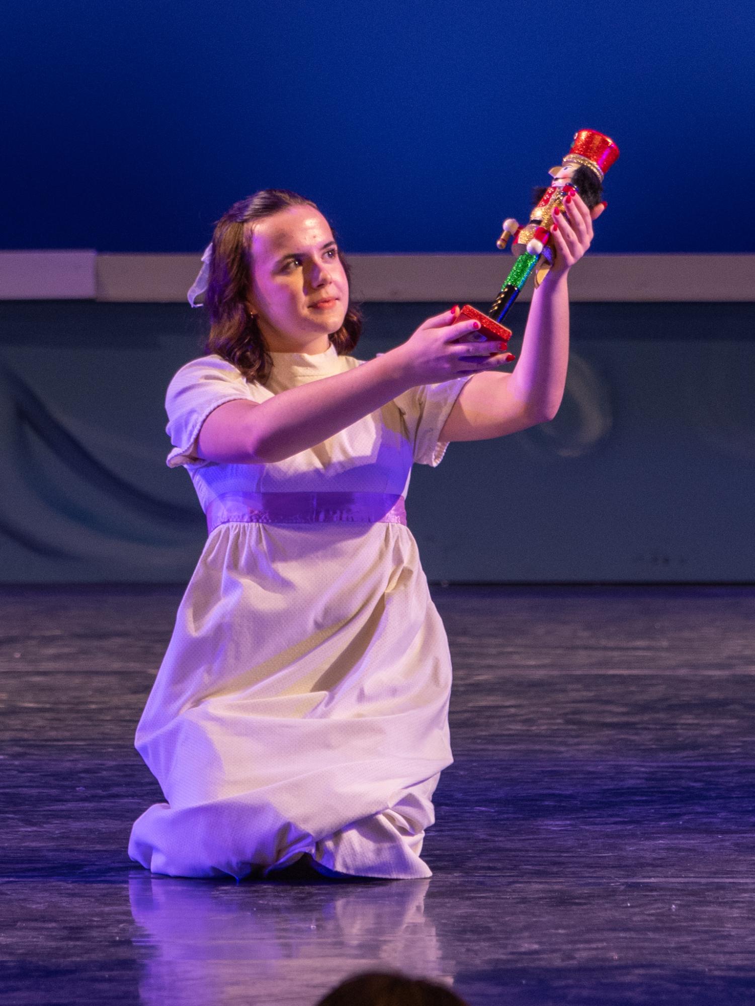 Clara, played by freshman Rigley Ohrt, holds up the nutcracker at the end of the performance.