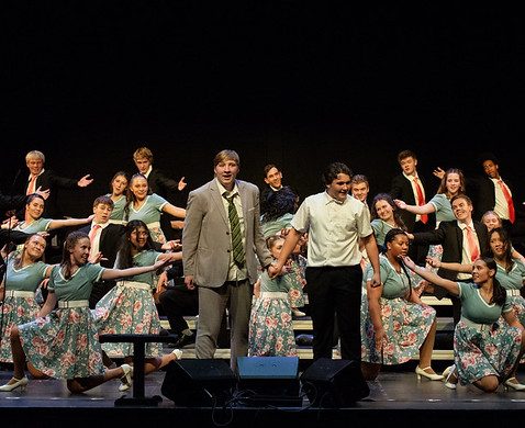 Happiness, Inc. members portray the father (senior Avery Theis) and son (junior Saul Ervin) in the choir's show.