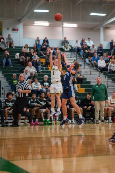 Elevating above the Xavier opponent, McKowen looks to hit a three from deep.