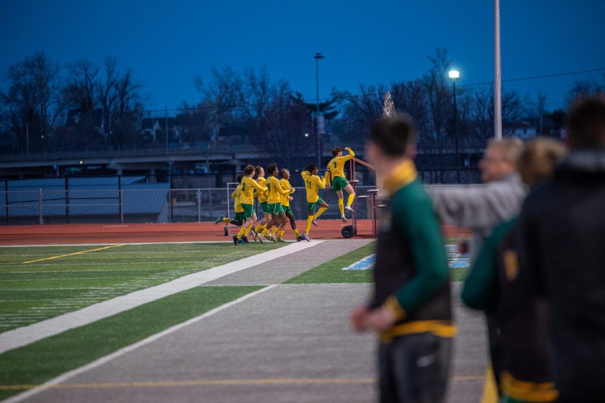 The Kennedy varsity boys soccer team celebrates in unison after a goal from senior Issac Schmidt 