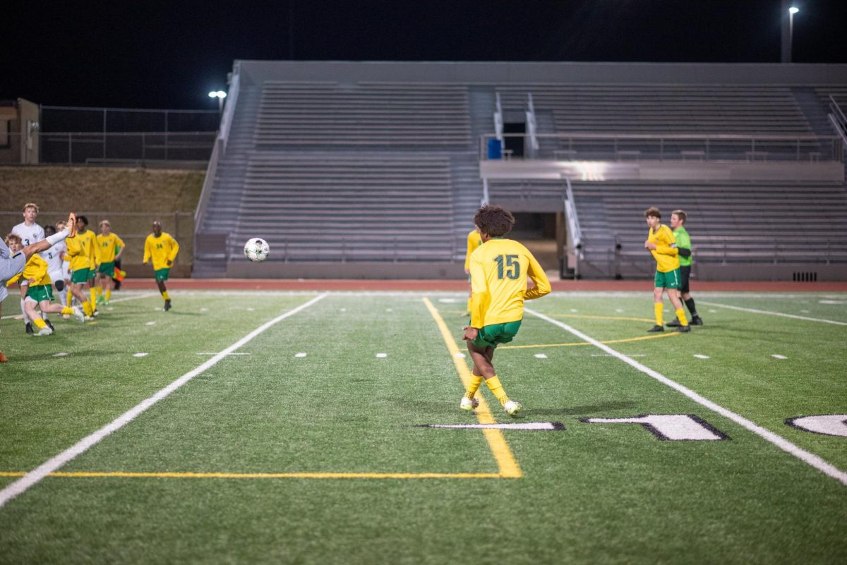 Senior Gaafar Osmanali aims over the Waterloo West defenders for a shot on goal. 