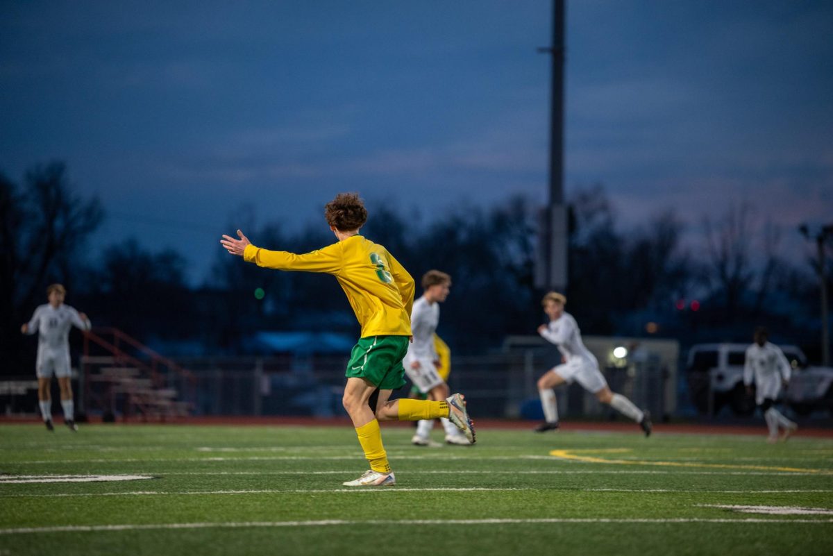 Sophomore Max Greene signals for the ball as he runs up the pitch. 