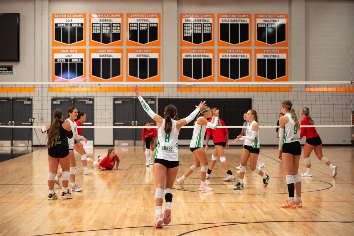 Junior outside hitter Hayden scott throws her hands up in celebration after a cougar point.