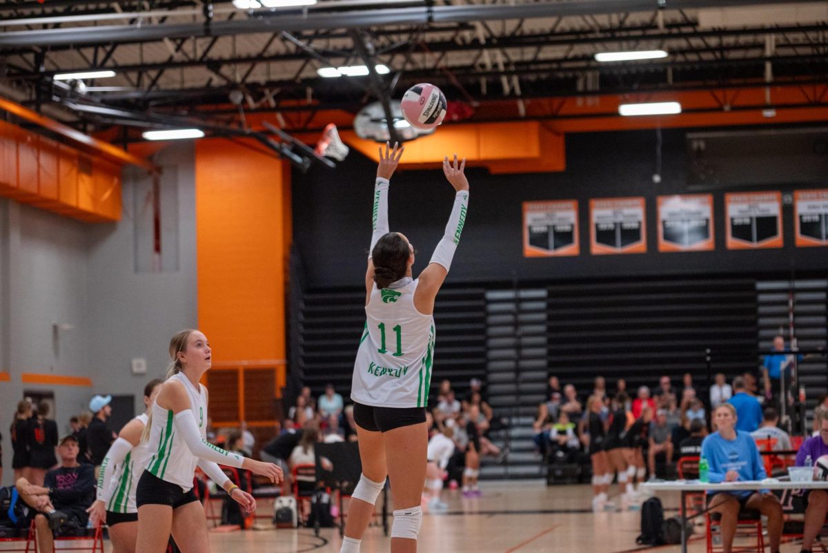 Junior setter Charley Lovell sets ball to sophomore outside Dylan Amling for a kill.