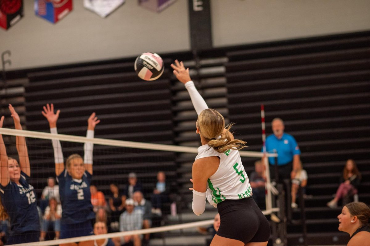 Middle hitter Addison Phillips goes up for a crucial kill against the Pleasant Valley spartans. 