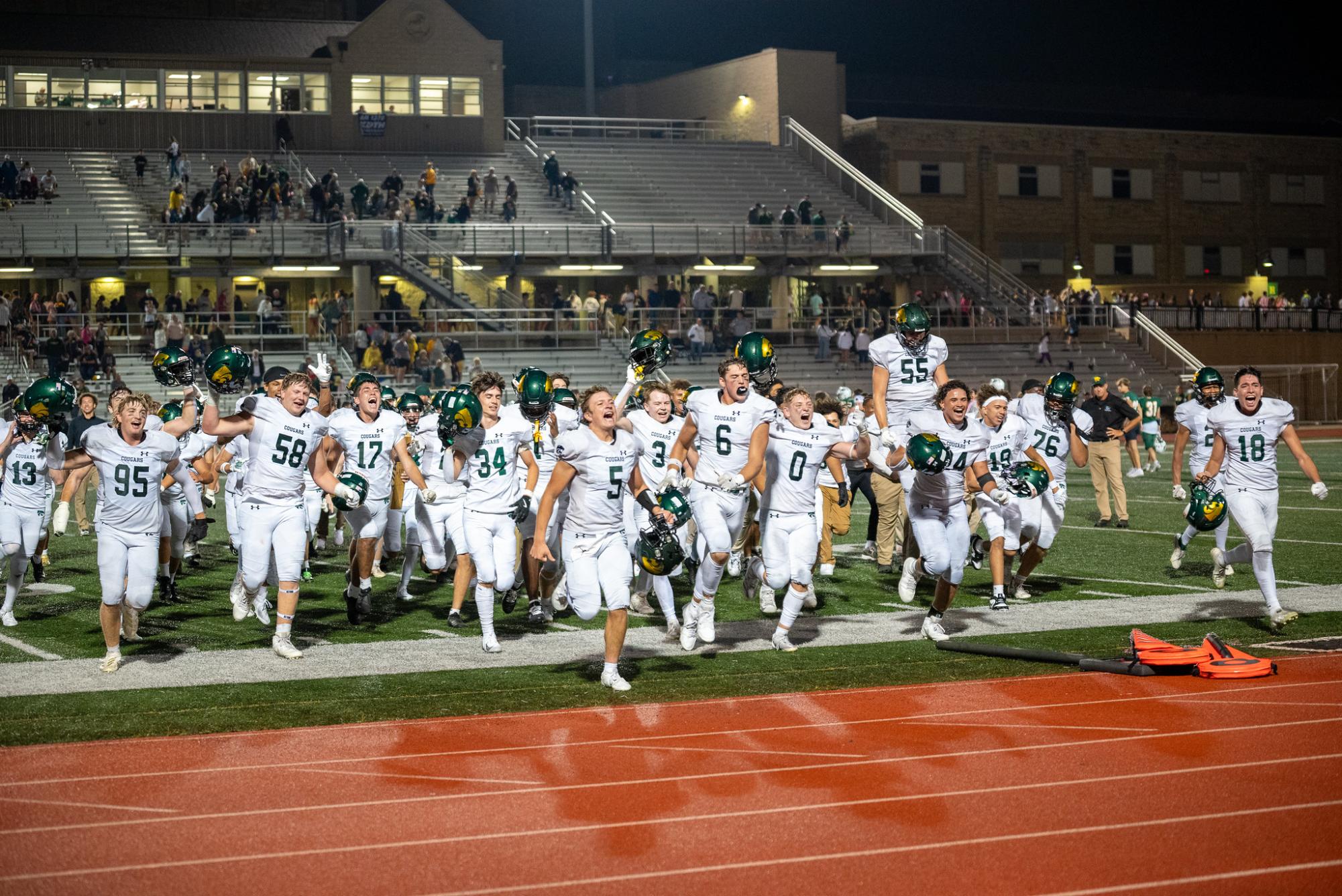 Celebrating after the 42-20 victory over the Dubuque Hempstead Mustangs, the Cougars sprint towards the student section