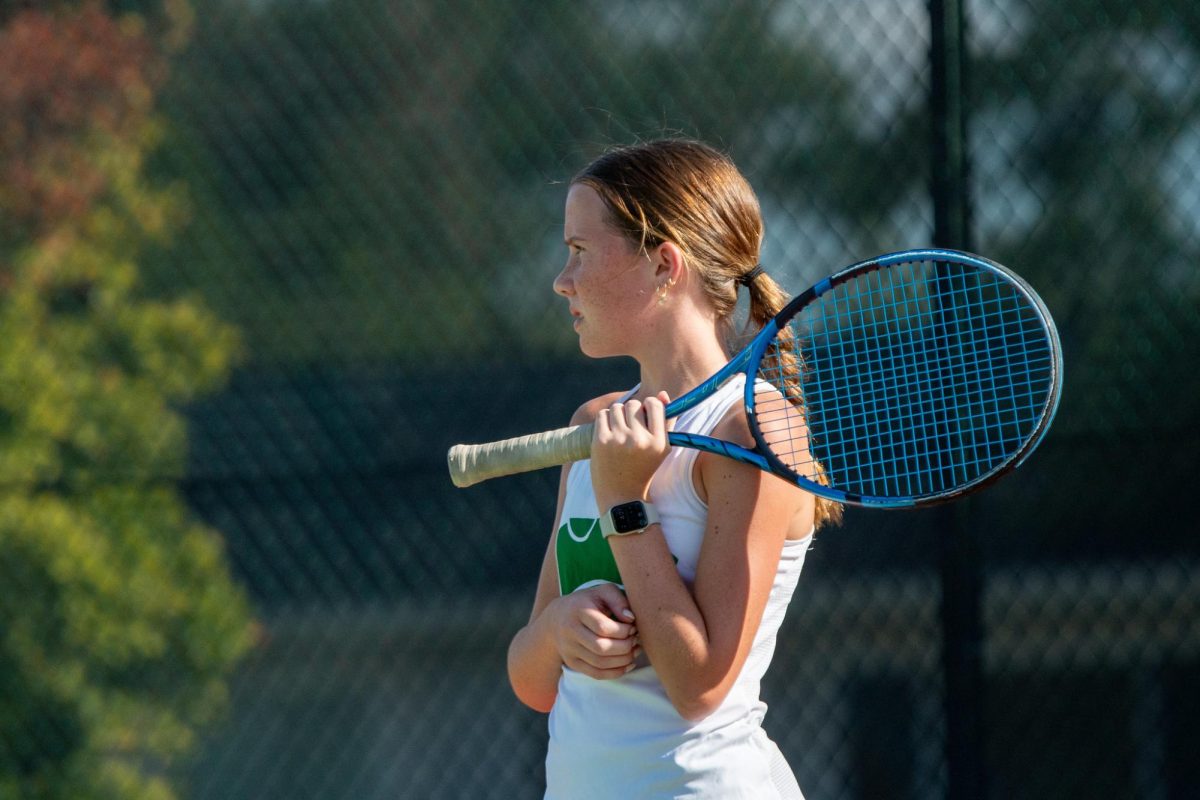 In between seves Freshman Aubrey Paulson thinks about how she can improve her hitting.