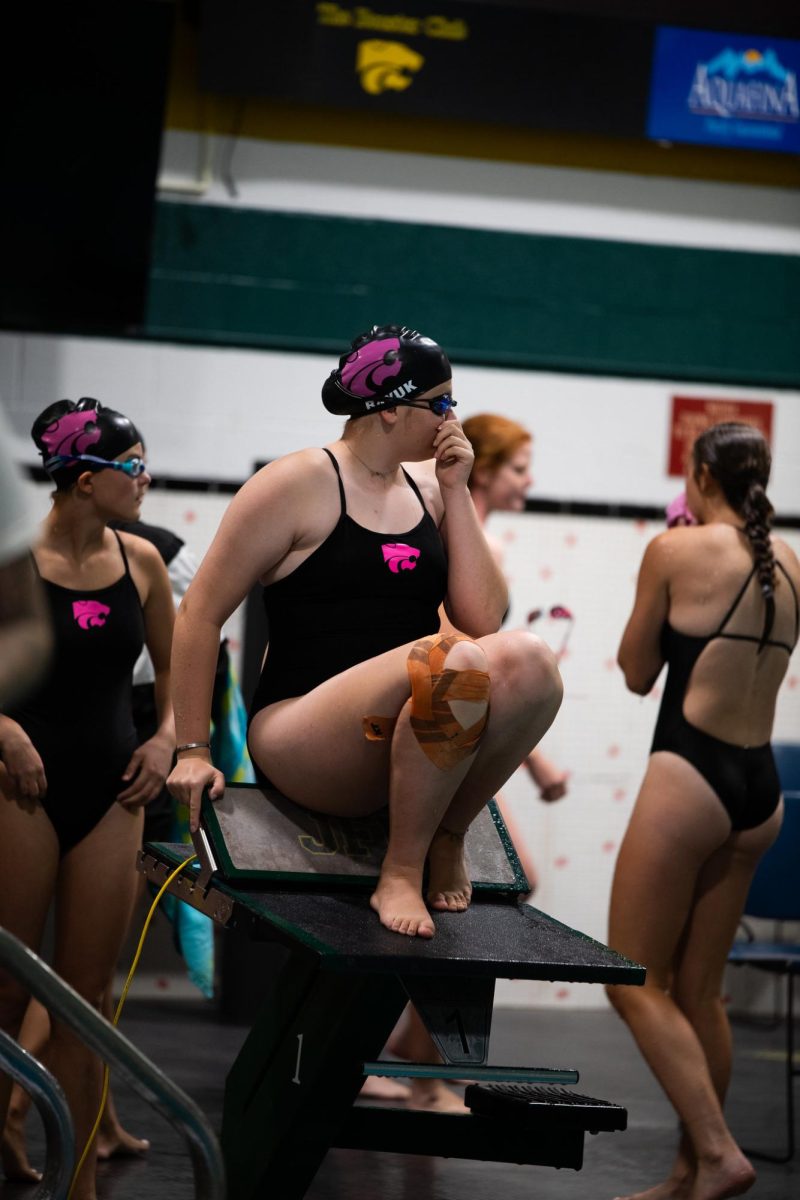 Lining up to compete, Natalie Bayuk sits up top a diving board at Kennedy JV girls September 9th swim meet.