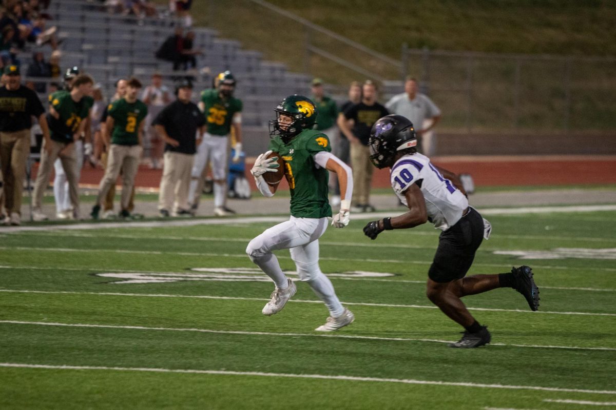 Burning the Waukee defensive back, Senior Brayden Peck runs the ball in unscathed for a Kennedy touchdown. 