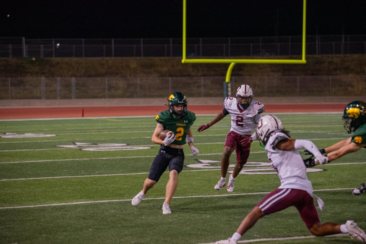 Faced head on with a Dowling defender, Senior Dawson Dougherty makes a move on dowling defense to advance upfield. 