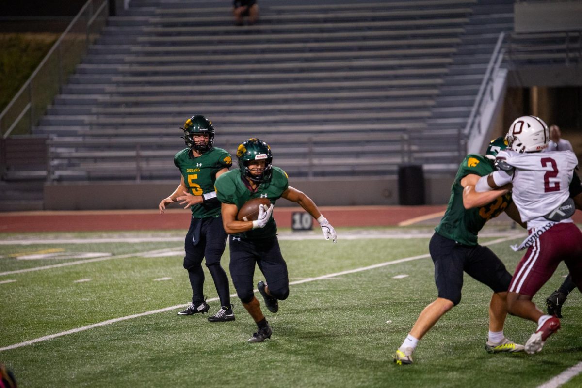 Junior running back Demarion Orr takes the ball down field for a Cougar first down. 