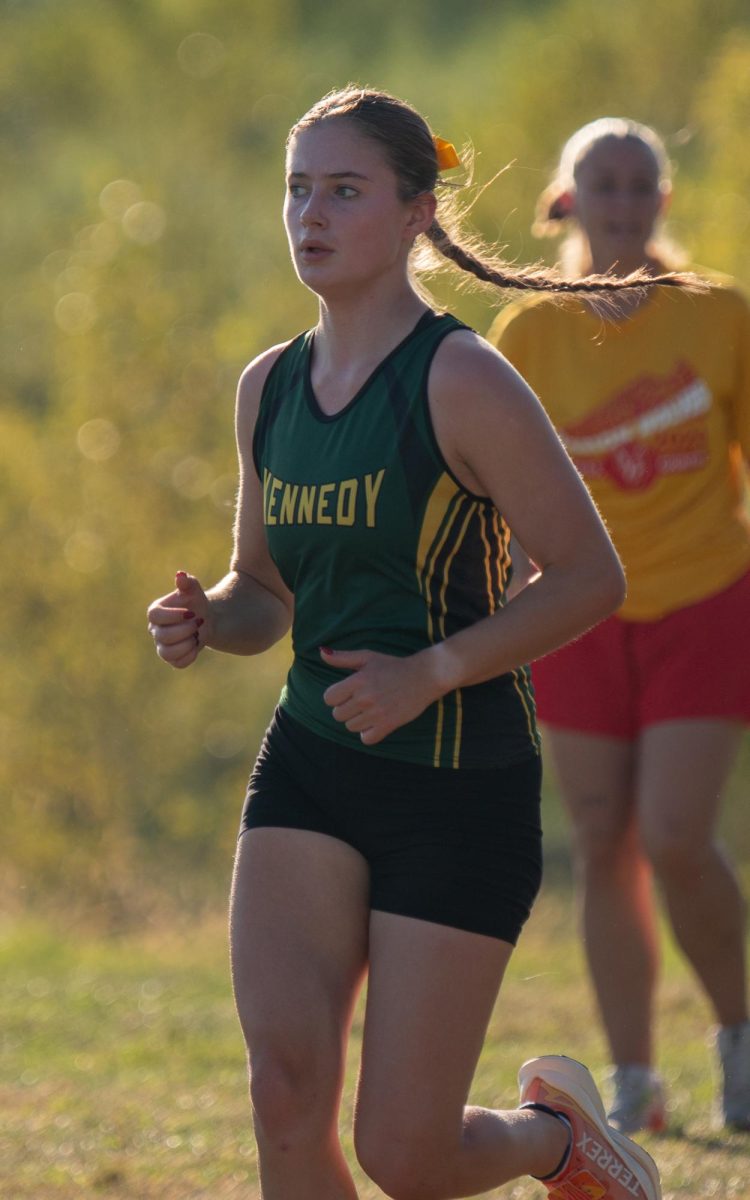 Focusing on her stride to finish, Senior Olivia Hallam runs to the finish line. 
