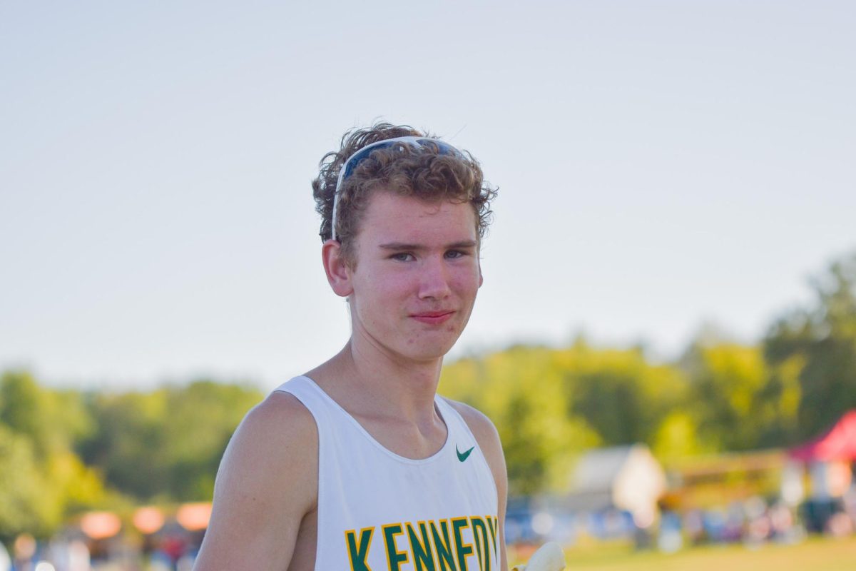 Looking out towards the race, Sophomore Kevin Primrose poses for the photo.