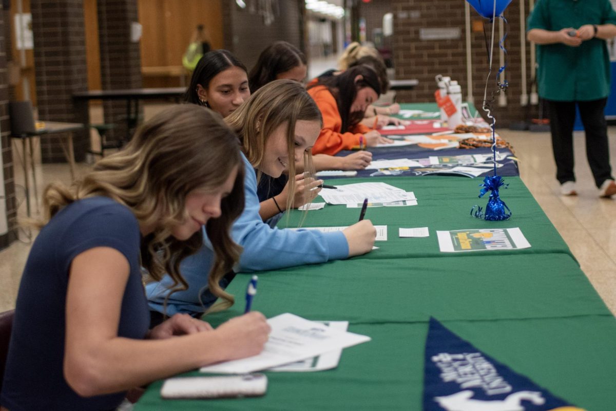 Seniors at Kennedy High school, sign their letters of intent for their chosen school.