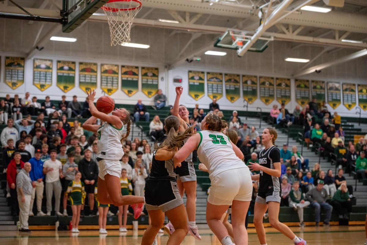 With everyone watching Sophomore Bentley Dill lays the ball up on Mount Vernon defenders. 