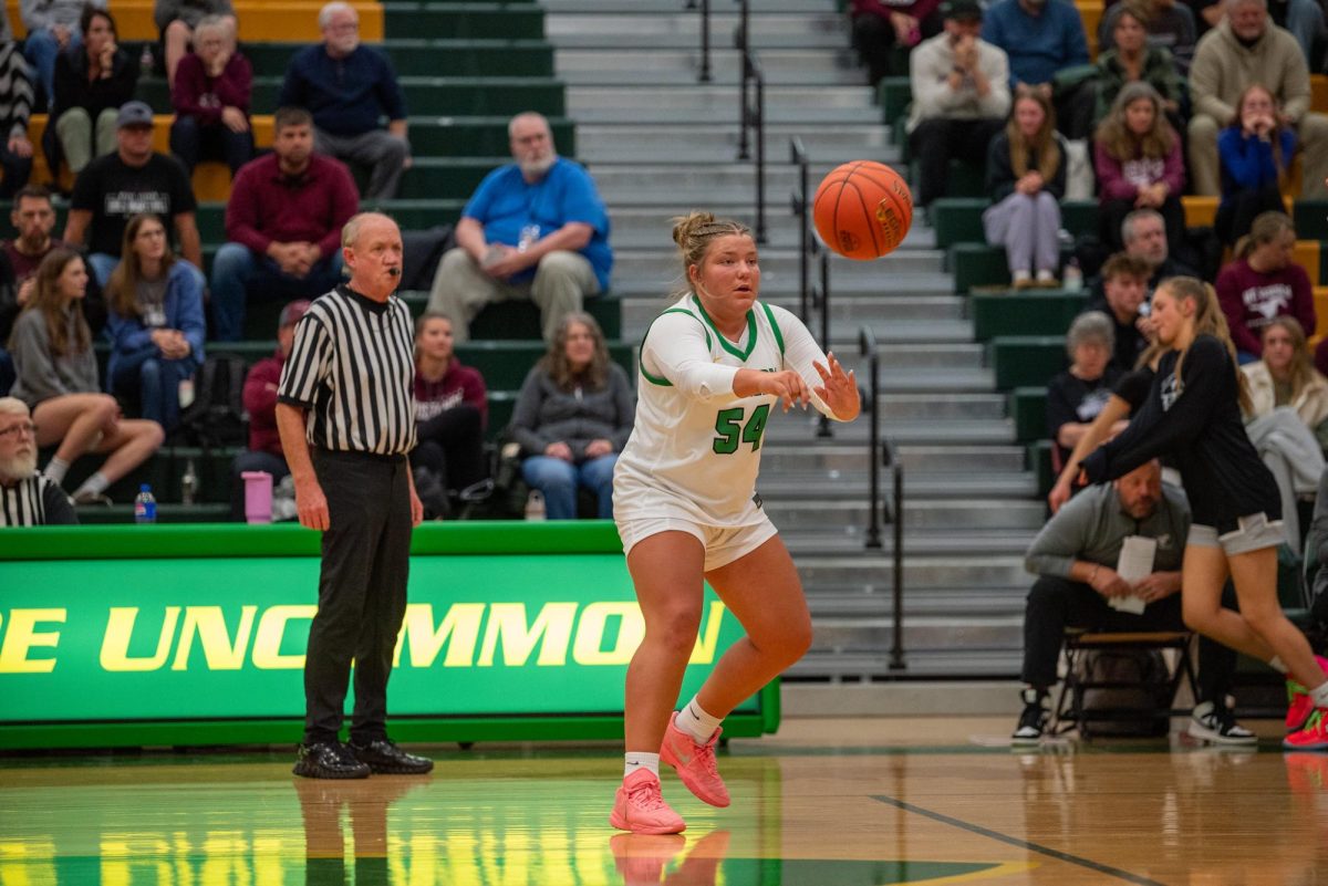 Sophomore Addy Stallman moves the ball around the court to her teammates.