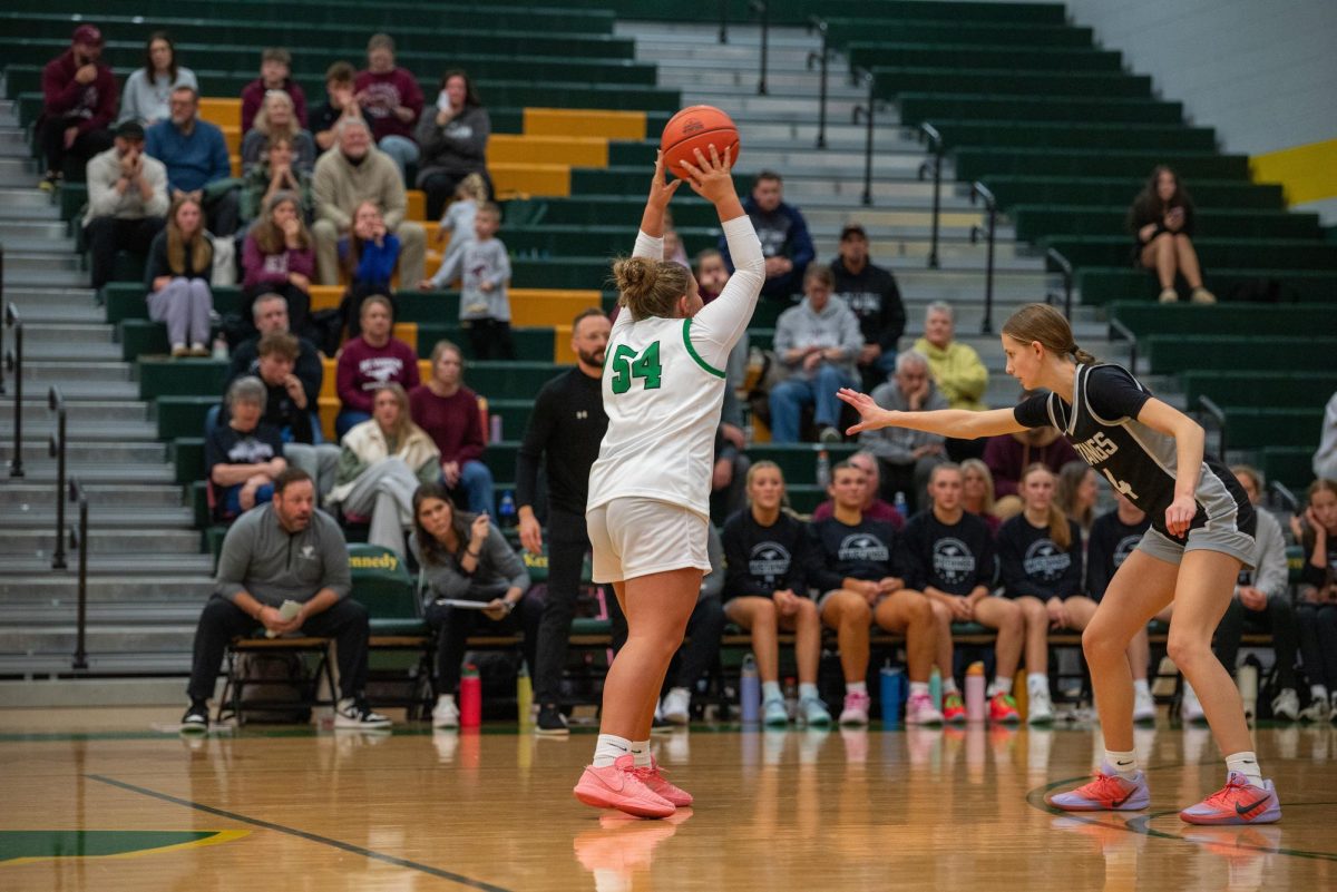 Creating movement in the offense, sophomore Addy Stallman passes the ball.