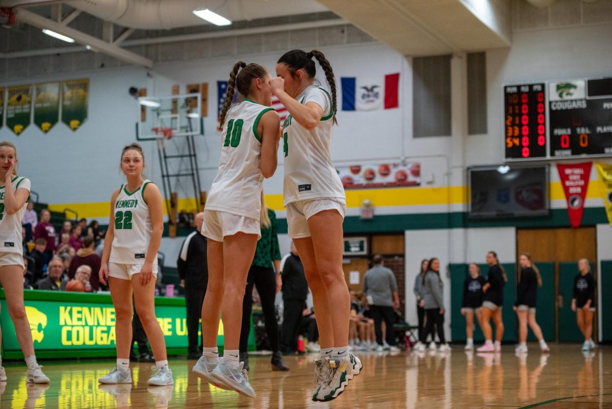 Checking into the game, Junior Bella Senters does her handshake with senior Emerson Blocker 