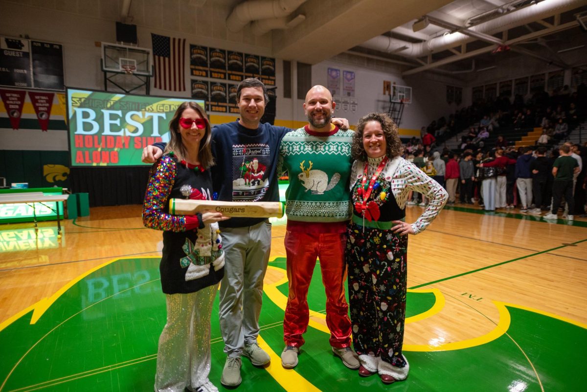 Kennedy spirit judges Mrs. Nekvinda, Mr. Divis, Mr. Clark, and Mrs. Arends pose with the spirit stick.