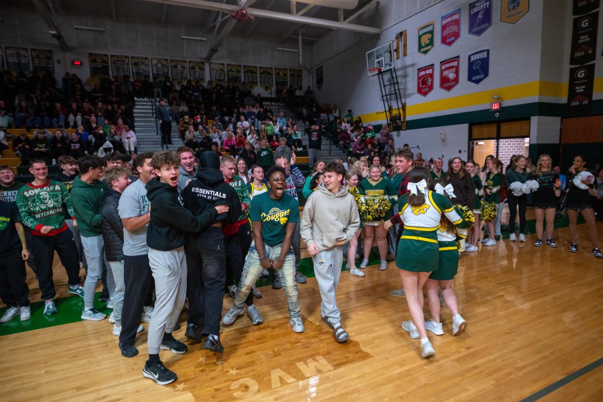 After winning a point win in the winter pep assembly, the juniors jump around in celebration.