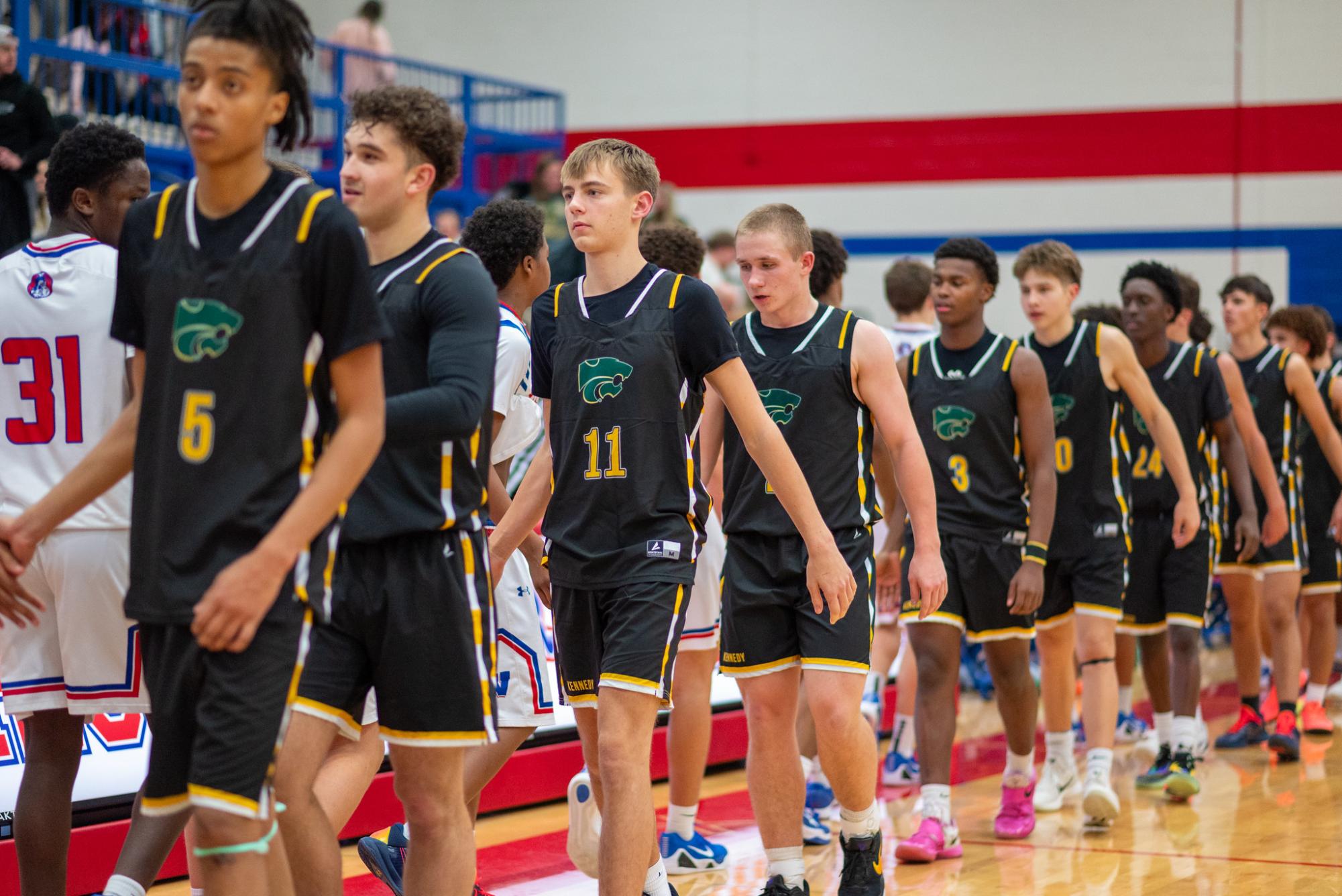 Walking in line, the Kennedy Cougars shake hands after a 68-55 victory over cross town rival Washington High School.