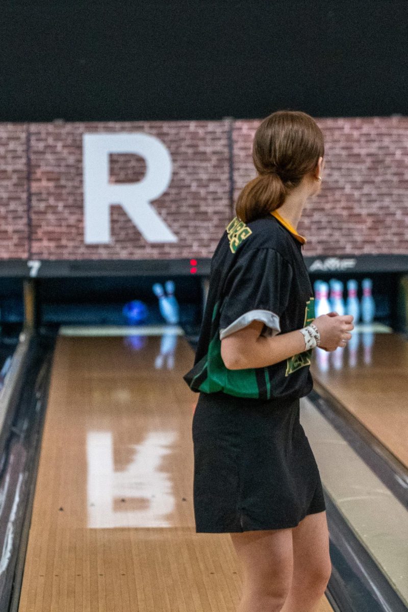 Watching the sixth pin hit the tenth pin, sophomore Emma Deeds follows through for the spare.